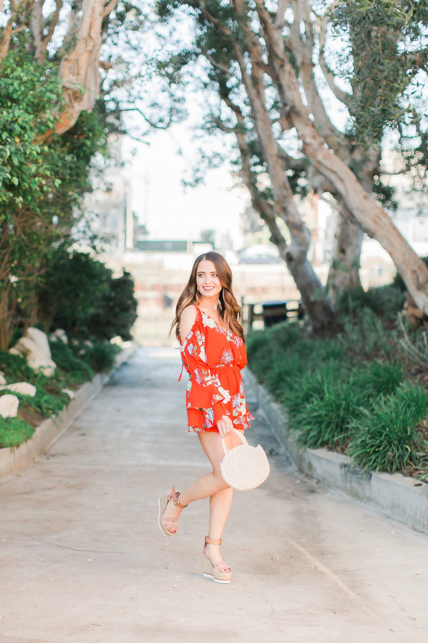 brunette in red floral romper - 3 Ways to Incorporate Florals Into Your Spring Wardrobe featured by popular Orange County fashion blogger, Maxie Elle