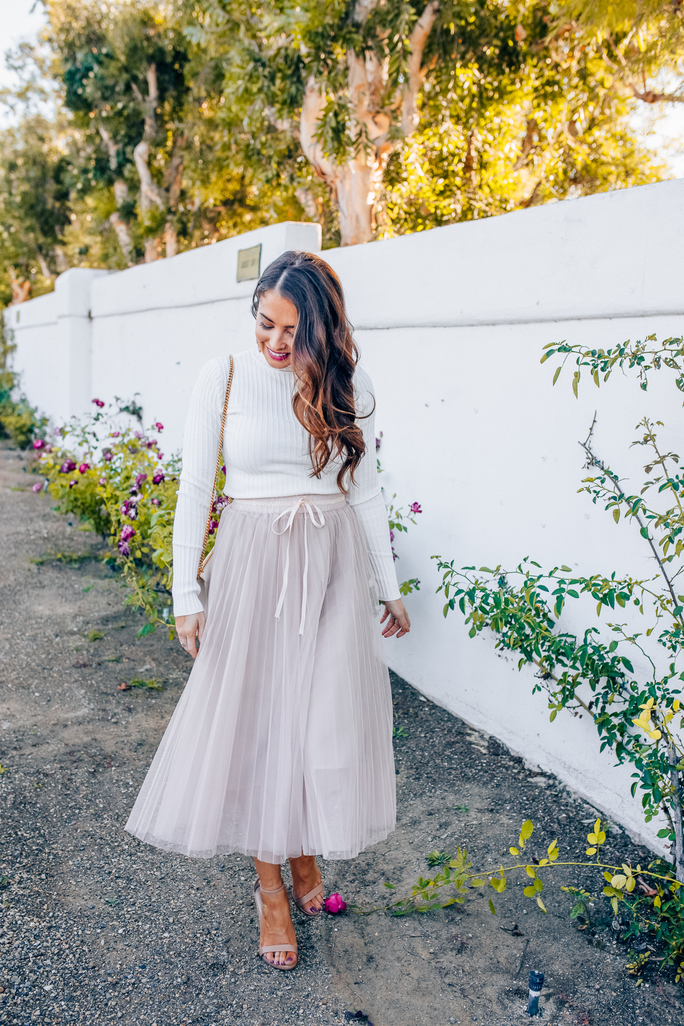 Tips to style a layered tulle skirt featured y top Los Angeles fashion blogger, Maxie Elise: image of a woman wearing a Chicwish long tulle skirt, Forever 21 cream turtleneck, Lisi Lerch earrings and Steve Madden sandals 