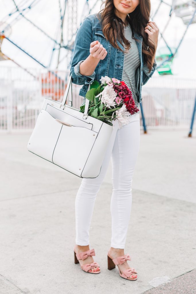 white purse with flowers and white jeans