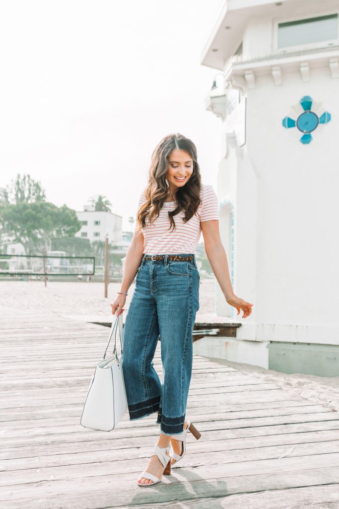 woman standing on boardwalk in tshirt and jeans
